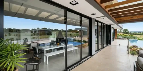 Aplicação de esquadrias em alumínio e vidro para corredores e áreas laterais, garantindo acabamento de alto padrão, proteção e harmonia com a arquitetura.